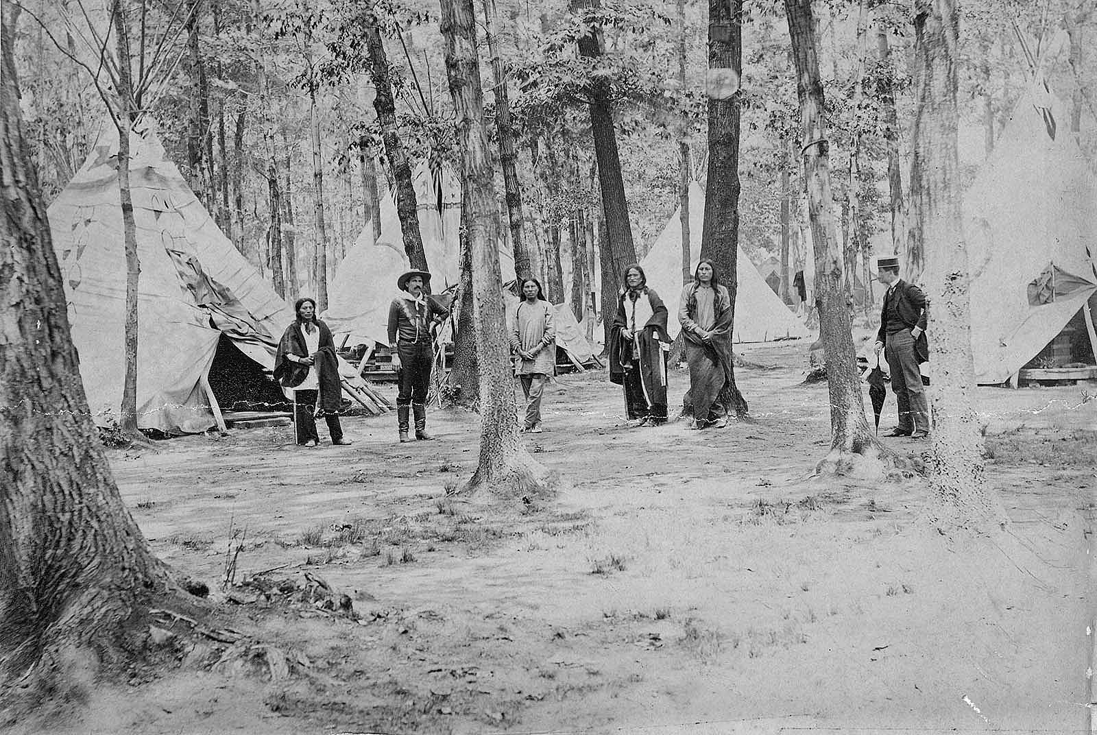 Wild West's Buck Taylor with the show's Indian encampment on Erostina Staten Island, ca. 1888. MS 006 William F. Cody Collection, McCracken Research Library. P.6.201