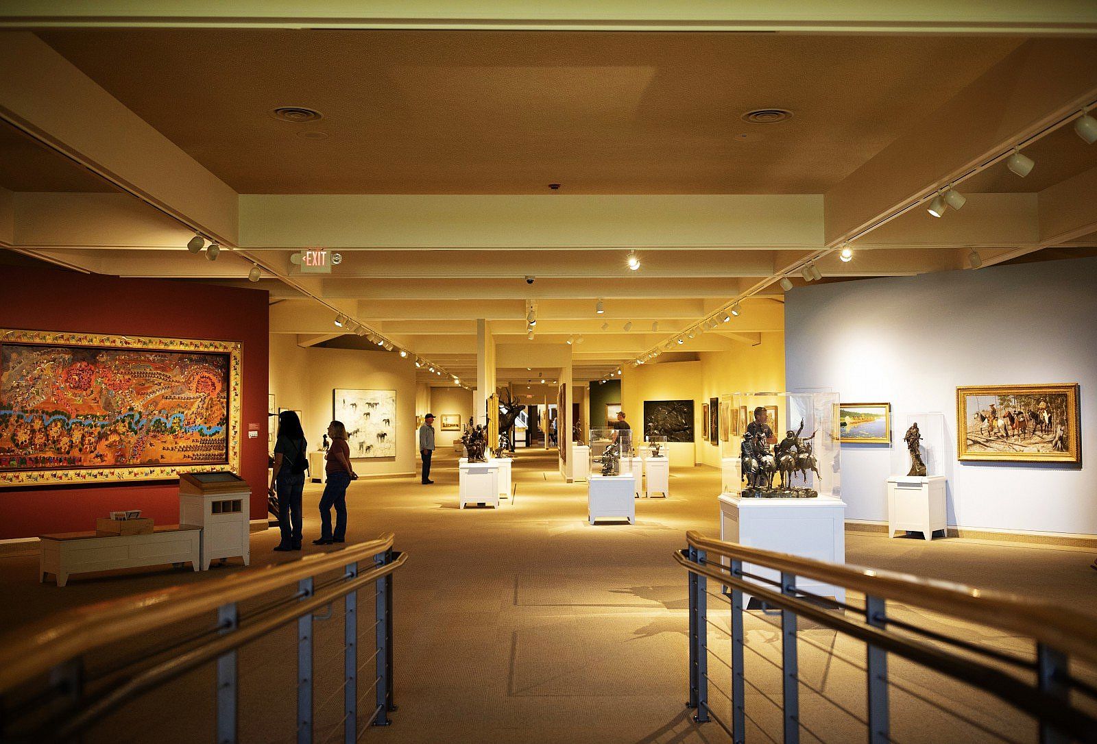 Visitors enjoy artworks at the Whitney Wester Art Musuem in Cody, WY.