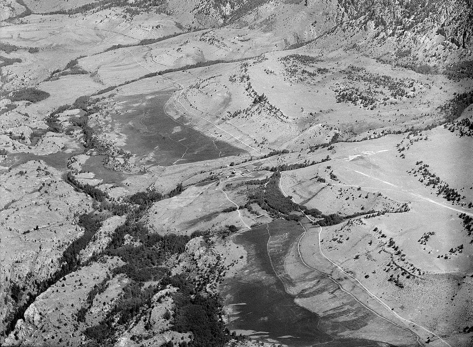 Aerial view of Switchback Ranch and Beartooth Mountains, early 1950s, by Jack Richard. MS 89 Jack Richard Photograph Collection, McCracken Research Library. PN.89.108.21044.02