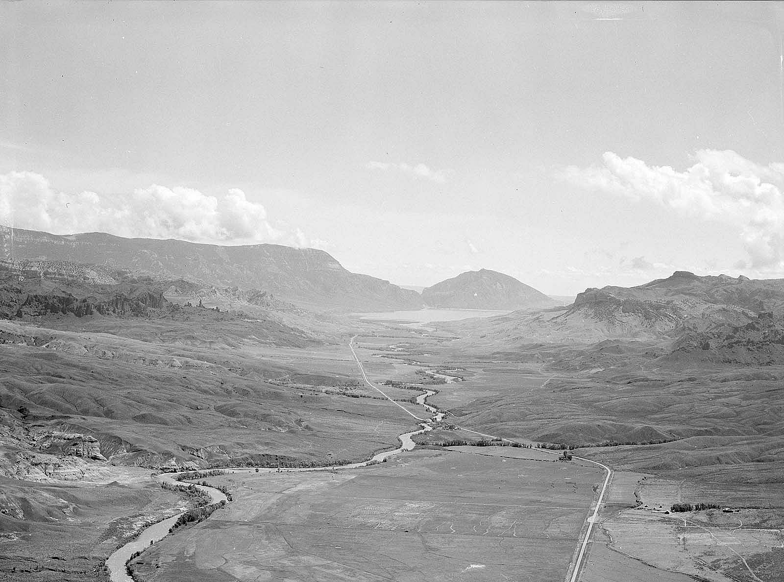 Aerial Aerial view of Wapiti Valley below with Rattlesnake Mountain on far left, Spirit (Cedar) Mountain center, and Sheep Mountain on right background. MS 89 Jack Richard Photograph Collection, McCracken Research Library. PN.89.29.4682.8of Wapiti Valley below with Rattlesnake Mountain on far left, Spirit (Cedar) Mountain center, and Sheep Mountain on right background. Hollister Ranch on bottom right with North Fork of Shoshone River flowing into Buffalo Bill Reservoir in background.