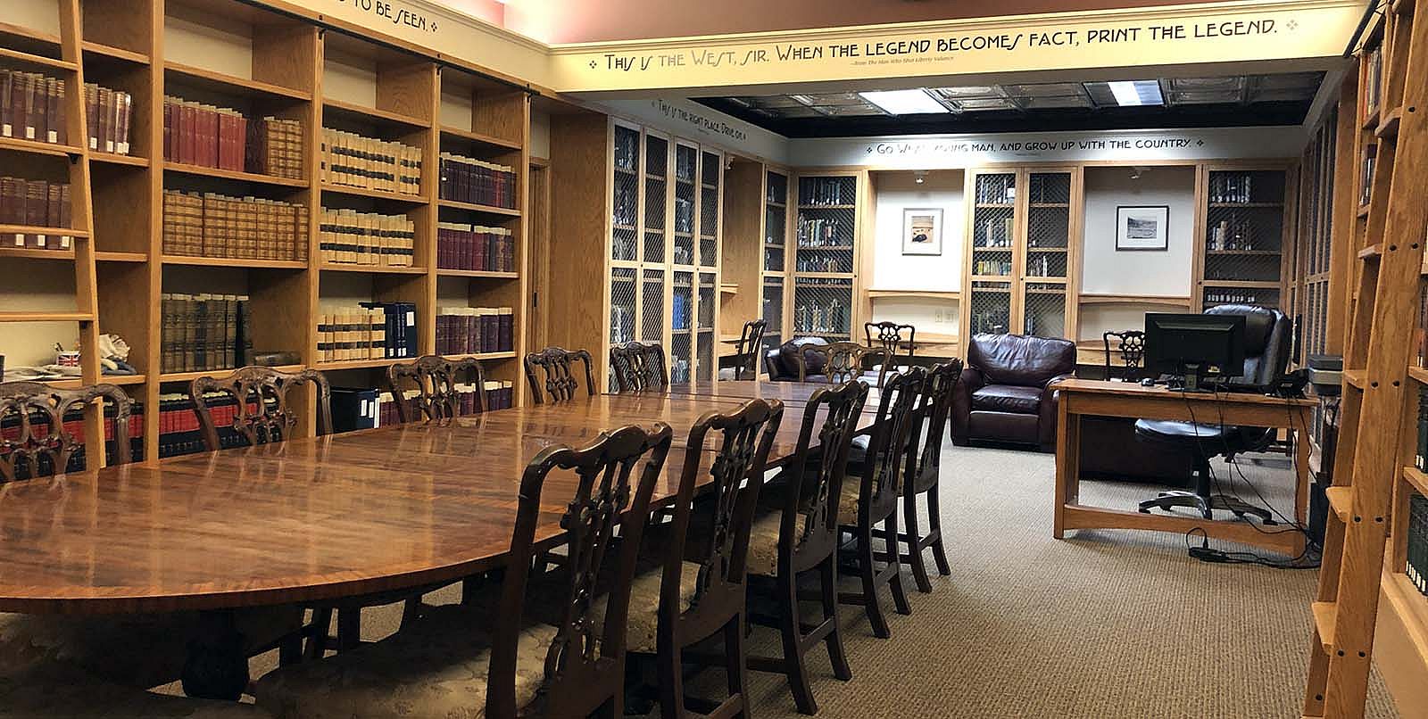 Reading room of the McCracken Research Library, with book stacks and large table