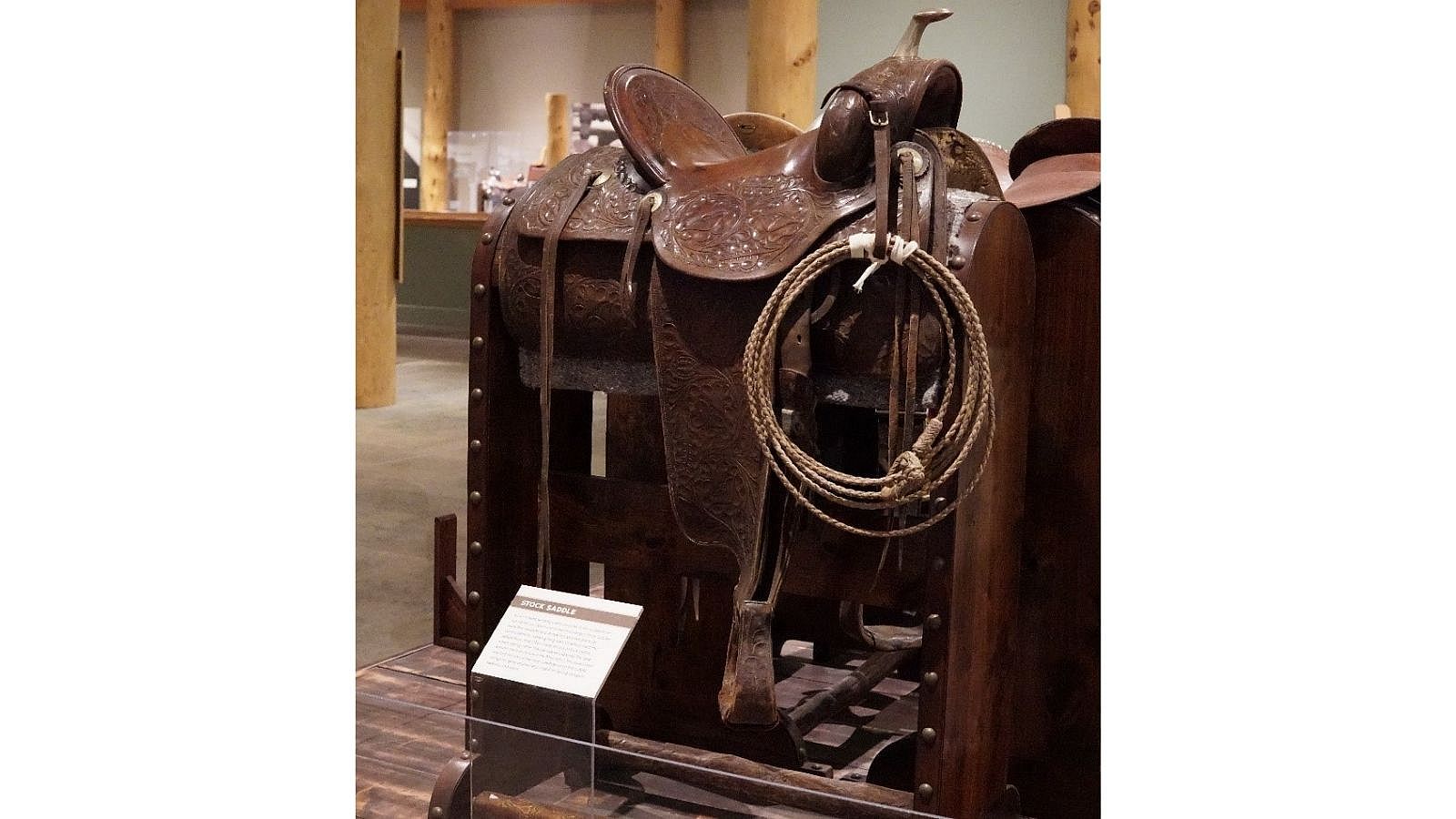 Stock Saddle on display, featuring detailed tooling and roping equipment.