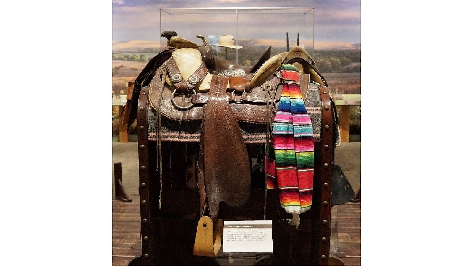 Vaquero Saddle on display with colorful saddle blanket, showcasing traditional design.