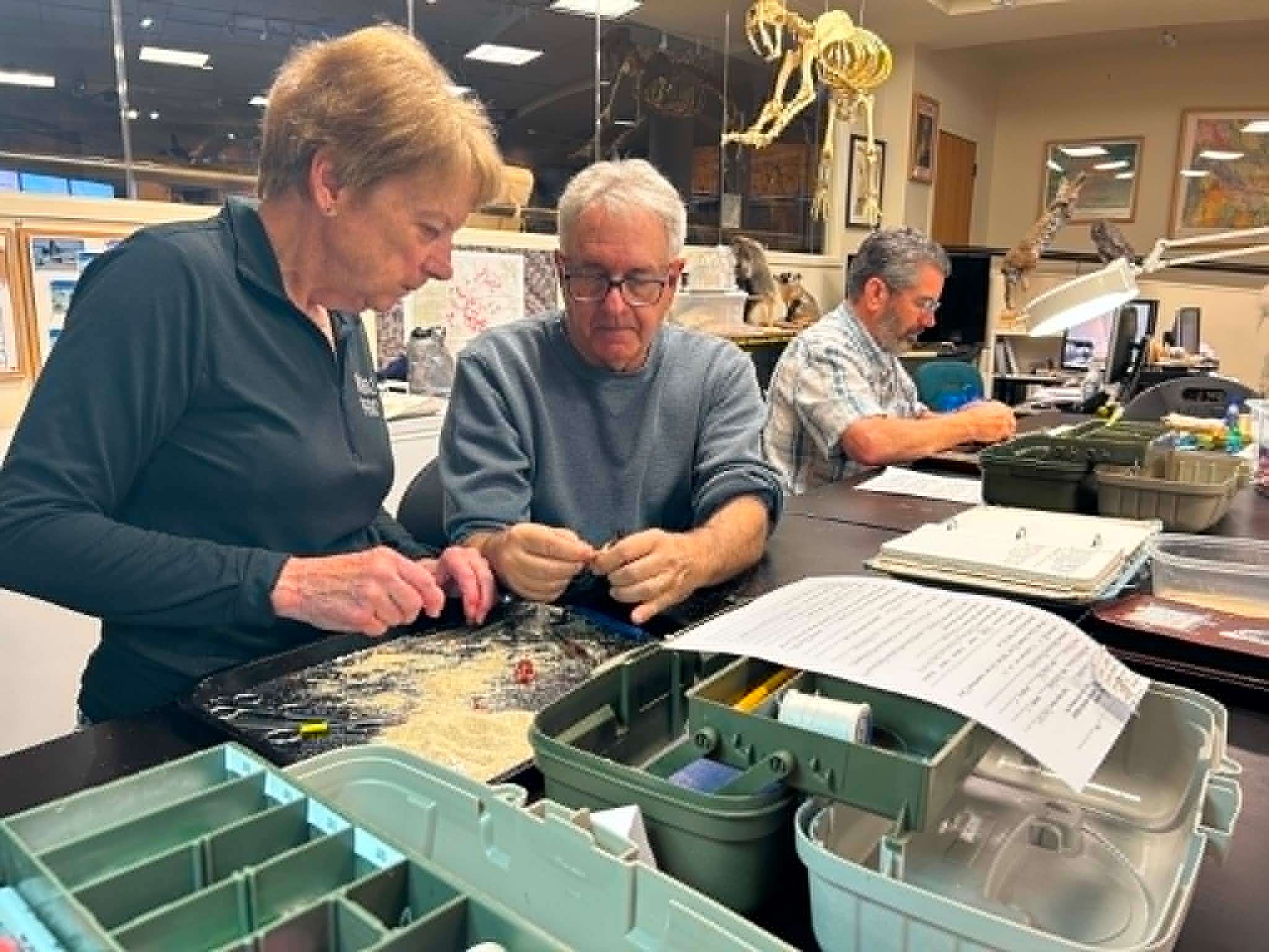 Dr. Andrew Engilis works with Jeanne to remove the body from the bird to prevent spoilage.