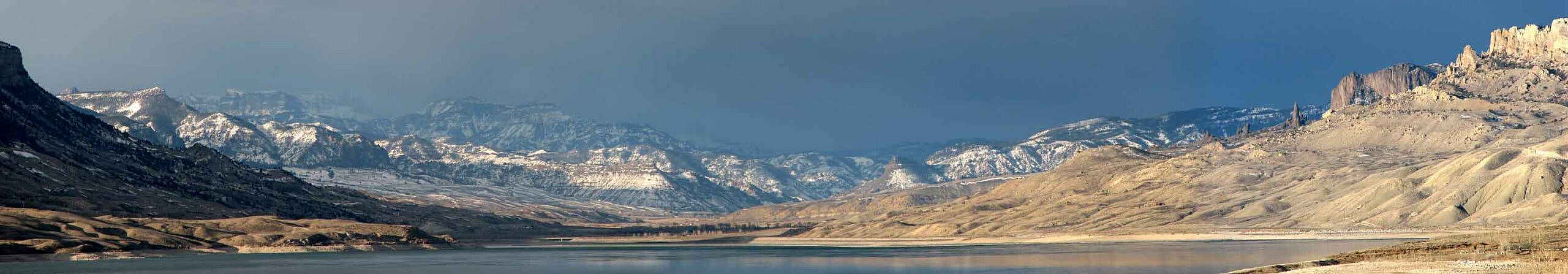 Gray sky over snow dotted mountains. Mack Frost photo.