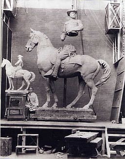 Alexander Phimister Proctor in his studio with the sculpture, Rough Rider, 1922.