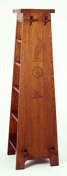 Sharp's oak Roycroft magazine pedestal, ca. 1905. Visible joints on the side show how the piece was constructed. Such "revealed design" elements are a common characteristic of Arts and Crafts furniture. The pedestal also bears the Roycroft mark, an orb and cross. Height 64 inches. 19.00.79