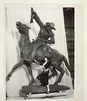 Gertrude Vanderbilt Whitney standing beside her sculpture, Buffalo Bill – The Scout, circa 1923.