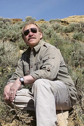 The author examines the site where a golden eagle parent captured a small prairie rattlesnake. Photo by Richard Jones.