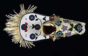 Cradleboard, Salish, Plateau 1919. Wood, tanned hide, muslin, glass beads, cowrie shells, abalone shells, mother of pearl, brass Simplot Collection, Gift of J.R. Simplot; NA.111.57