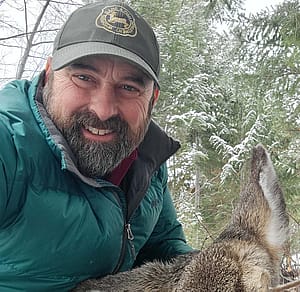 Tony Mong in green jacket and olive drab cap.