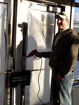 Maintenance worker melting ice on the locks.