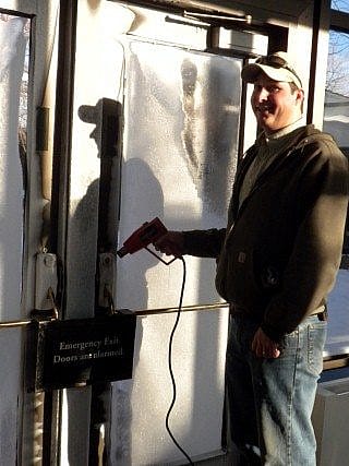 Maintenance worker melting ice on the locks.