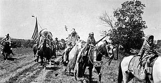 Horse and riders parading at Crow Fair, Crow Agency, Montana. Photo by W.H.D. Koerner, 1927. P.78.4452 (detai)