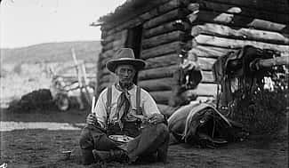 Old Charlie Collins looks a bit "worse for wear" with his tin plate of trail vittles, ca. 1920. Charles Belden black and white glass plate negative. Gift of Mr. and Mrs. Charles Belden. PN.67.39 (detail)