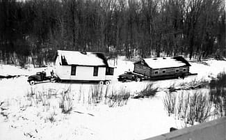 Moving houses from Elbowoods, North Dakota, across the frozen Missouri River. Image courtesy of Marilyn Cross Hudson.
