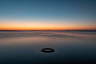 “Fishing Cone.” Fishing cone hot spring, in the West thumb area of Yellowstone Lake, was once a geyser with eruptions as high as 40 feet. As water levels have risen in the lake, the once-active geyser has now fallen silent. What Lies Beneath: Exploring Yellowstone Lake’s Mysterious Vents / Photographs by Chris Linder, Woods Hole Oceanographic Institution.