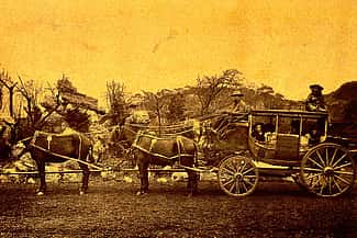 Deadwood stagecoach, here pictured in Buffalo Bill's Wild West, ca. 1900. Buffalo Bill claimed the coach was a refurbished stagecoach that had indeed been robbed on the Cheyenne - Deadwood route, later attacked by Indians, and then abandoned alongside the trail where he reclaimed it. Gift of Mr. and Mrs. George Strobel. P.6.59
