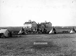 “U.S. School of Indians at Pine Ridge, 1891.” John C.H. Grabill was an early and active photographer in South Dakota. This print captures the stark contrast between the traditional ways of the Native Americans and the new social order. MS 35 Richard Pohrt Collection. P.35.17.2