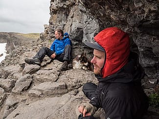 Jenny Nichols is the filmmaker for the Invisible Boundaries project. Here Arthur Middleton and Joe Riis of the project shelter during a storm while watching for elk.