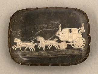 Agate brooch given to Mrs. William F. Cody, i.e. Louisa Cody, and featuring a coach and four, ca. 1890. Hand-carved, 1 x .75 inches. Original Buffalo Bill Museum Collection. 1.69.335