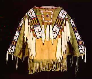 Man's Shirt. Austin Box, Southern Ute, Security, Colorado, 1989. Tanned deer hide, pre-1880 glass beads, seam binding, ermine, dyed porcupine quills, commercial dyes, nylon thread. Gift of Mr. & Mrs. William D. Weiss. NA.202.1007