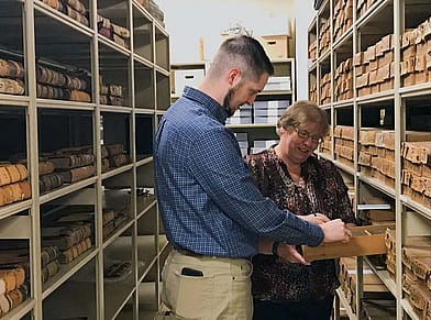 Danny Michael and Jesi Bennett look at Savage records in the McCracken Research library.