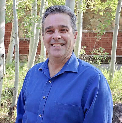 Headshot of Jeremy Johnston in the Center of the West's Braun Garden.