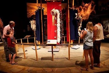 Another family enjoys looking at museum displays