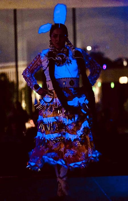 Sarah Ortegon jingle dress dancing under black light. Courtesy photo.