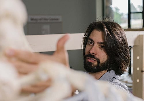 Corey Anco studying bones