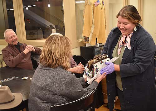 Plains Indian Museum Assistant Curator Hunter Old Elk shows a beaded pursed from the museum's collection.