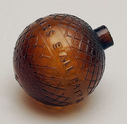 A Treasure from Our West: Cross-hatched patterned amber glass target ball. 1.69.1852