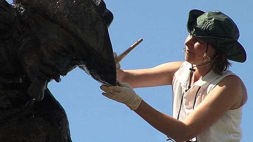 Marianne Marti cleaning The Scout sculpture. Gertrude Vanderbilt Whitney (1875-1942). "Buffalo Bill—The Scout," 1924. Cast by Roman Bronze Works, N.Y. Bronze, 149 inches. Gift of the artist. 3.58