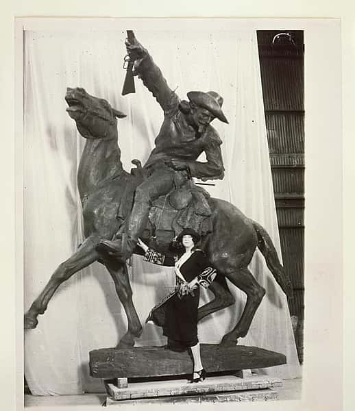 Gertrude Vanderbilt Whitney standing beside her sculpture, Buffalo Bill – The Scout, circa 1923.