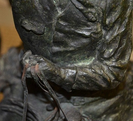Areas of bronze disease and flaking patina.