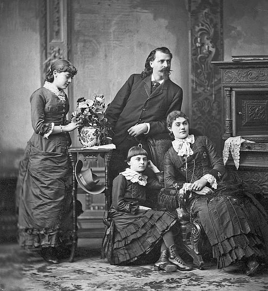 Studio portrait of William F. Cody with wife Louisa and daughters Arta and Orra.