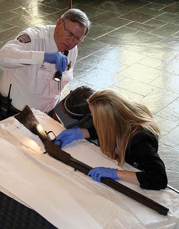 Security Manager Mike Brown and Firearms Curator Ashley Hlebinsky examine the Model 1873 Winchester discovered at Great Basin National Park.