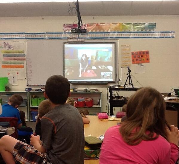 Students in the classroom watch presenters from the Buffalo Bill Center of the West.