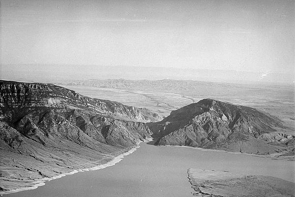 Aerial view of Buffalo Bill Reservoir with Rattlesnake Mountain on left and Spirit (Cedar) Mountain on right. McCullough Peaks and Big Horn Mountains in background. MS 89 Jack Richard Photograph Collection. PN.89.8.1499.13