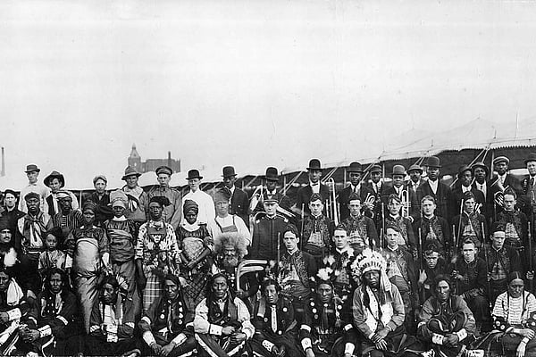Large group of people, some with musical instruments.