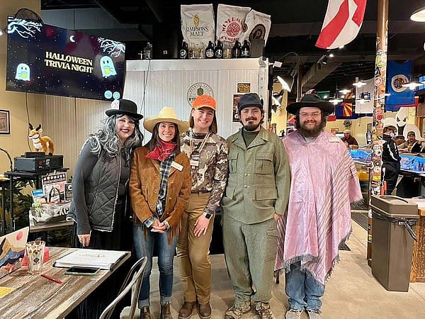 Five people in Halloween costumes at a trivia event at Cody Craft Brewing.