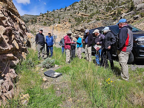 Field trip participants explore geology with Larry Oliveria.