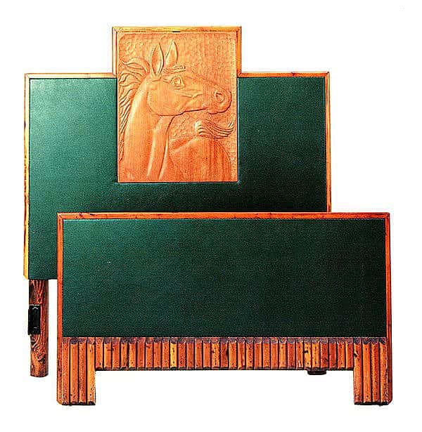 One of a set of twin beds, this Molesworth bedstead has a plywood framework, fir legs, and shaped pole and leather trim. The carved horse decoration was completed by one of a number of western artisans contracted to do piecework for Molesworth. Courtesy of the Paul Stock Foundation