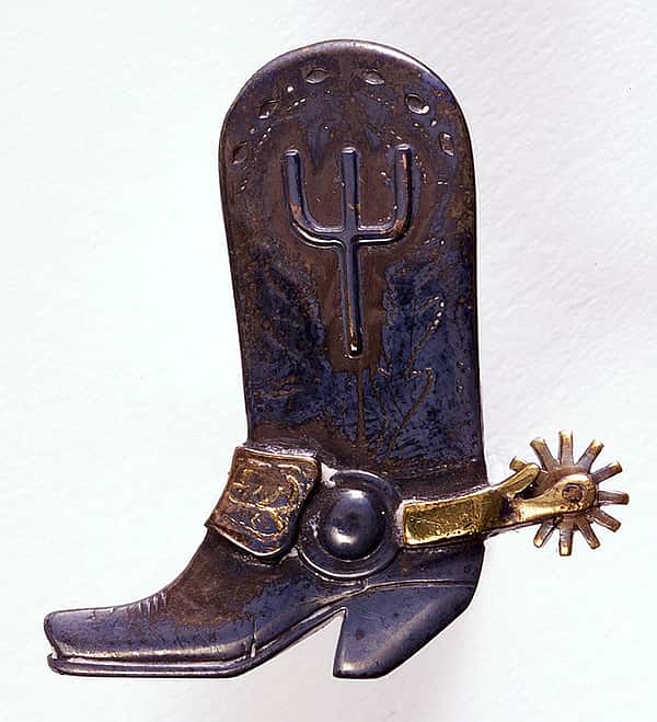 Cowboy boot bolo tie slide with Pitchfork Ranch brand. Sterling silver, 10-karat gold, and brass. Edward H. Bohlin, Inc. 1.69.2432
