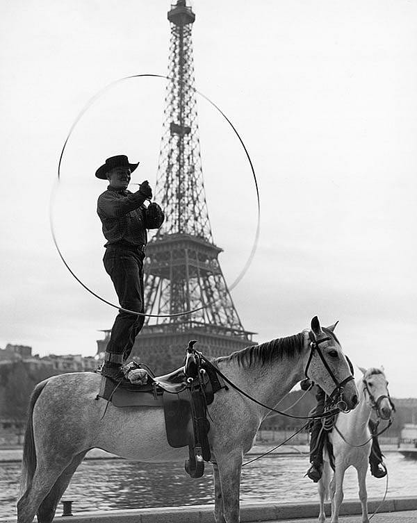 Treasures from Our West: Charles Belden photo of trick roper/rider in front of the Eiffel Tower. P.67.1590