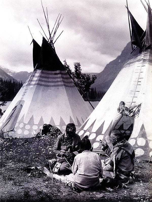 "Tail-Feathers-Coming-Over-The-Hill, Yellow Wolf, and James Willard Schultz (Apikuni) at Upper Two Medicine Lake." Roland Reed recorded a visit of author J.W. Scott in a Blackfeet camp. MS 43 Roland Reed Collection. P.43.57