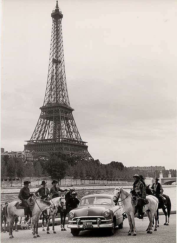 Treasures from Our West: Charles Belden photo of cowboy in front of Eiffel Tower. P.67.1588