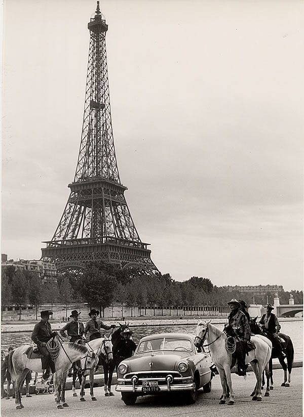 Treasures from Our West: Charles Belden photo of cowboy in front of Eiffel Tower. P.67.1588