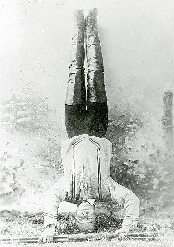 Mishaps in shooting exhibitions often came as a result unusual stances such as Johnny Baker who's ready to shoot at a target while standing on his head. Vincent Mercaldo Collection. P.71.34